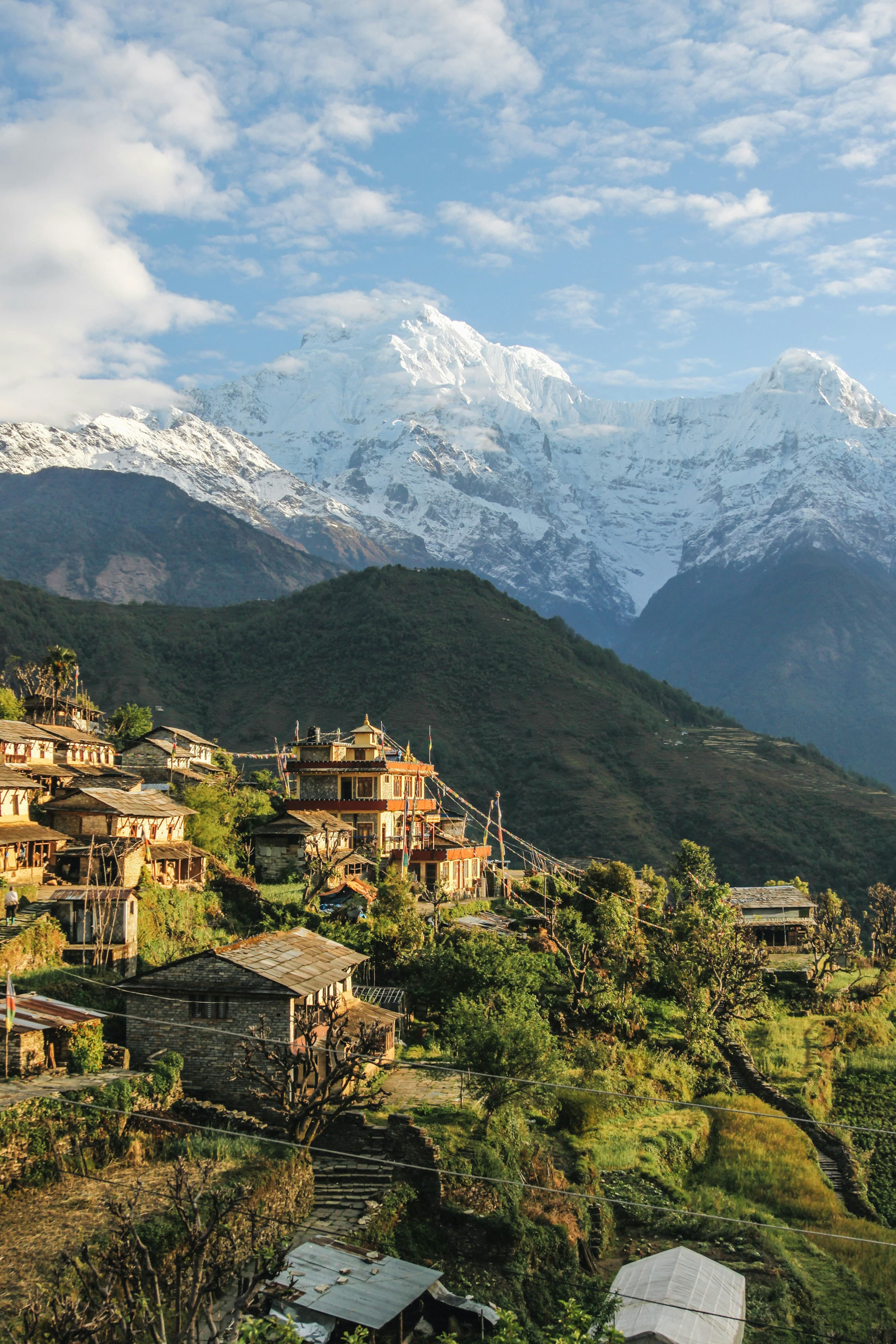 A Gurung village on terraced hillside below the snow peaks of the Annapurna Himalaya